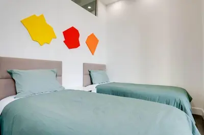 a bedroom with two beds with colorful pillows at Best of Brickell's Luxury Suite with Pool and Gym in Miami