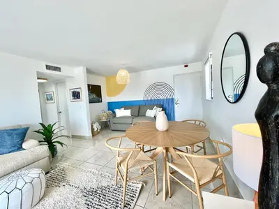 a living room with a table and chairs and a couch at Large 1 bedroom apartment with free private parking in Miami Beach
