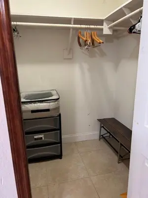a room with a desk and a bed and a table at Paradise in Miami