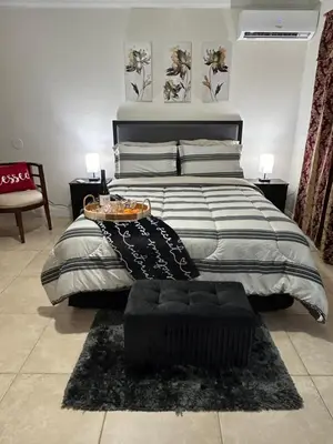 a bedroom with a large bed with a table on it at Paradise in Miami