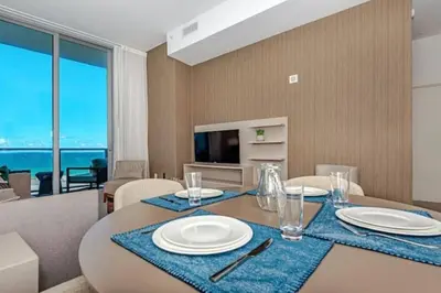 a dining room with a table with a view of the ocean at Amazing apartment - Lyfe Resort & Resident in Hollywood