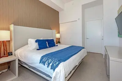 a bedroom with a large bed with blue pillows at Amazing apartment - Lyfe Resort & Resident in Hollywood