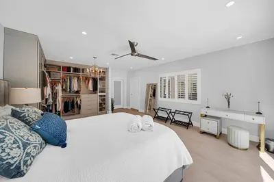 a bedroom with a large white bed and a desk at Casa la Miami - Central location Villa with Pool & Gym in Miami
