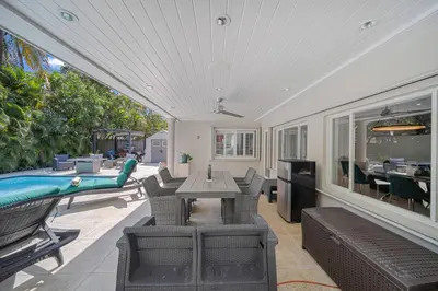 a patio with a table and chairs and a pool at Casa la Miami - Central location Villa with Pool & Gym in Miami