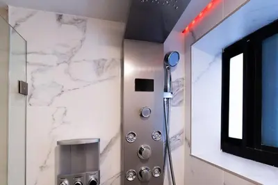 a bathroom with a shower and a mirror at Elegant Miami Apartment East Little Havana / Free Parking in Miami