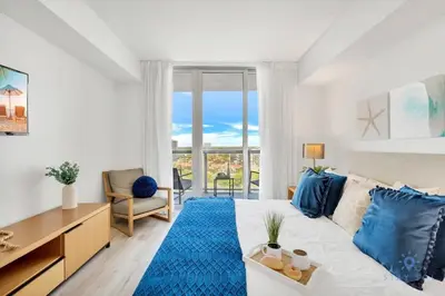 a living room with a white couch and a blue rug at Amazing Pool - Gym - Complementary Shuttle in Hallandale Beach