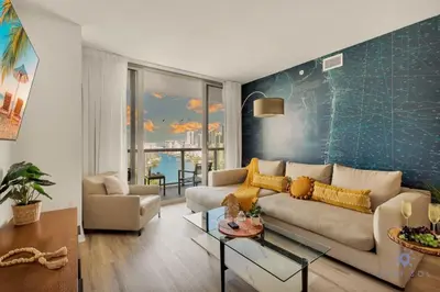 a living room with a couch and a table at Amazing Pool - Gym - Complementary Shuttle in Hallandale Beach