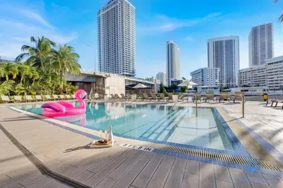 a large swimming pool with a city skyline in the background at Spectacular View with Balcony, Pool, Near Beach in Hallandale Beach