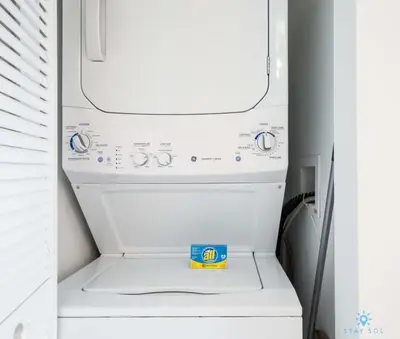a white washer and dryer in a refrigerator at Infinite View, Balcony with Gym and Amazing Pool in Hallandale Beach
