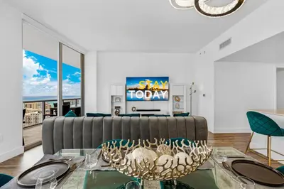 a living room with a couch and a table at Beachwalk Resort - PENTHOUSE IN THE SKY 3BDR and 3BA LUXURY CONDO DIRECT OCEAN VIEW in Hallandale Beach
