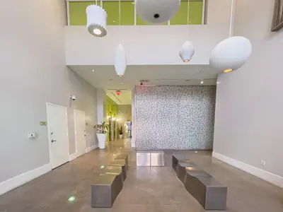 a hallway with a row of benches in a building at Center Stage- Downtown Parking Pool Hot Tub in Miami