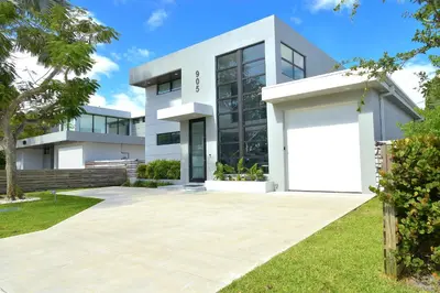 a white house with a large white garage at Topo Encanto - Designer Villa, Sundrenched Paradise! in Fort Lauderdale