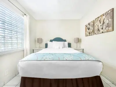 a white bedroom with a large bed and a window at Hollywood by the Sea in Hollywood