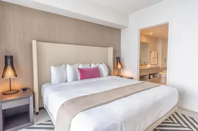 a bedroom with a large white bed with a pink pillow at Hyde Beach House 2309 in Hollywood