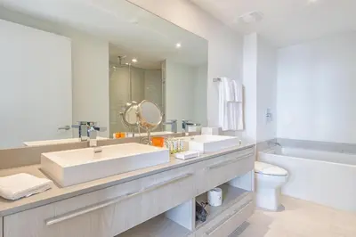 a bathroom with two sinks and a tub and a toilet at Hyde Beach House 2309 in Hollywood