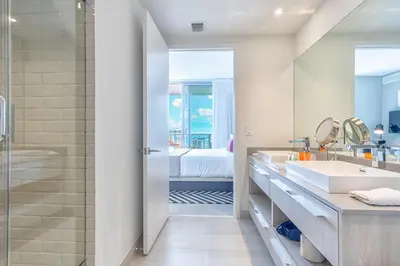 a bathroom with two sinks and a tub and a shower at Hyde Beach House 2309 in Hollywood