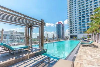 a swimming pool with lounge chairs and a building at Hyde Beach House 2309 in Hollywood