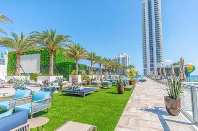 a hotel patio with chairs and palm trees at Hyde Beach House 2309 in Hollywood