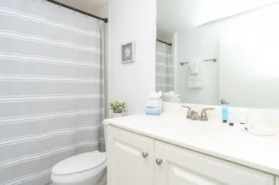 a white bathroom with a toilet and a sink at Marina Bay 406 in Miami Beach