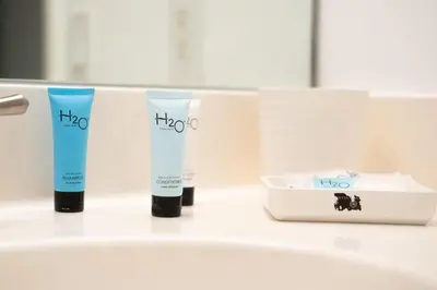 a group of three tubes of hair products on a counter at Marina Bay 406 in Miami Beach