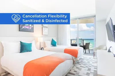 two beds in a hotel room with the words cancellation flexibility sanctated and distracted at Lyfe Beach Resort 3804 in Hollywood Beach