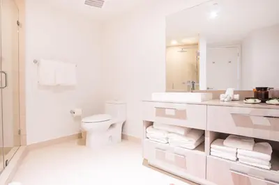 a white bathroom with a toilet and a sink at Lyfe Beach Resort 3804 in Hollywood Beach