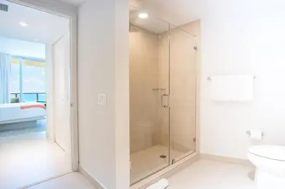 a white bathroom with a shower and a toilet at Lyfe Beach Resort 3804 in Hollywood Beach