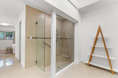 a bathroom with a shower with a glass door at Spacious Modern Mansion w Pool & Sauna in Hollywood close to Beach in Hollywood