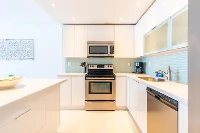 a kitchen with a stove and a microwave at Ocean Reserve 1006 in Miami Beach
