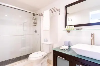 a bathroom with a toilet and a sink and a shower at Ocean Reserve 1006 in Miami Beach