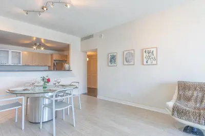 a kitchen and living room with a table and chairs at Ocean Reserve PH6 in Miami Beach