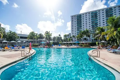 a large swimming pool with chairs and a building at Ocean Reserve PH6 in Miami Beach