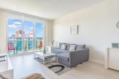 a living room with a couch and a large window at Ocean Reserve PH6 in Miami Beach