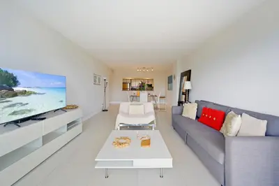 a living room with a couch and a tv at Ocean Reserve 1524 in Miami Beach