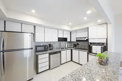 a kitchen with stainless steel appliances and granite counter tops at Ocean Reserve 1524 in Miami Beach