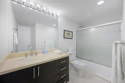 a white bathroom with a sink and a toilet at Ocean Reserve 1524 in Miami Beach