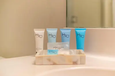 a bathroom with a sink with a group of products on it at Golden Bay 408 in Miami Beach