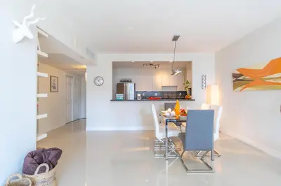 a dining room and kitchen with a table and chairs at Ocean Reserve 725 in Miami Beach