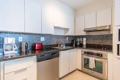 a kitchen with white cabinets and a counter top at Ocean Reserve 725 in Miami Beach