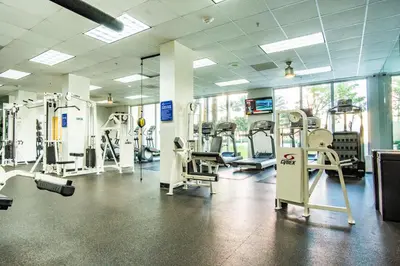 a gym with several treadmills and machines in it at Ocean Reserve 725 in Miami Beach