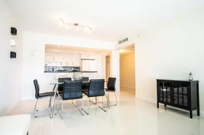 a kitchen and dining room with a table and chairs at Ocean Reserve 927 in Miami Beach