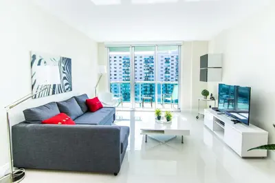 a living room with a couch and a tv at Ocean Reserve 1112 in Miami Beach