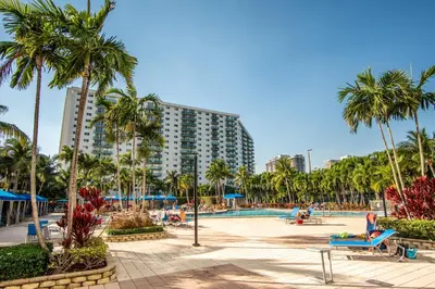 a resort with palm trees and a swimming pool at Ocean Reserve 1404 in Miami Beach