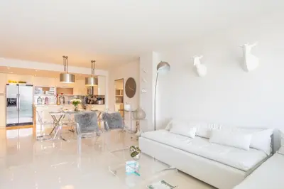 a living room with a white couch and a kitchen at Ocean Reserve 1508 in Miami Beach