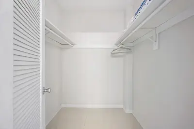 a walk in closet with white walls and white floors at Ocean Reserve 1616 in Miami Beach