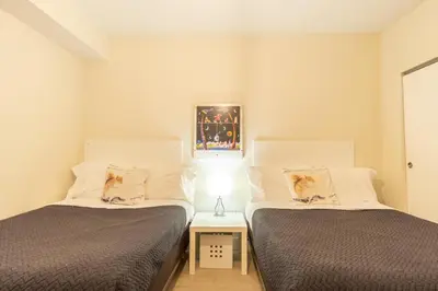 two beds in a room with two dogs sitting on them at Golden Bay 508 in Miami Beach