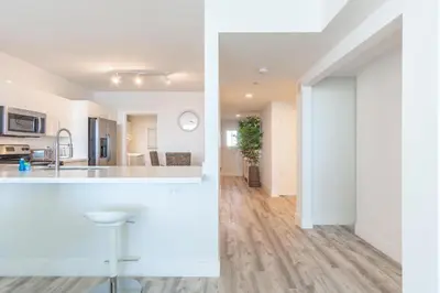 a kitchen and a living room with white walls at Golden Bay 606 in Miami Beach
