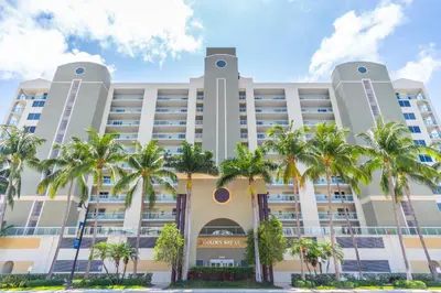a building with palm trees in front of it at Golden Bay 606 in Miami Beach