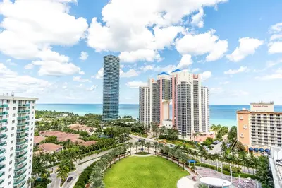 a view of a city with tall buildings and the ocean at Ocean Reserve PH1 in Miami Beach