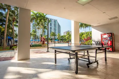 a ping pong table in a building with palm trees at Ocean Reserve PH1 in Miami Beach
